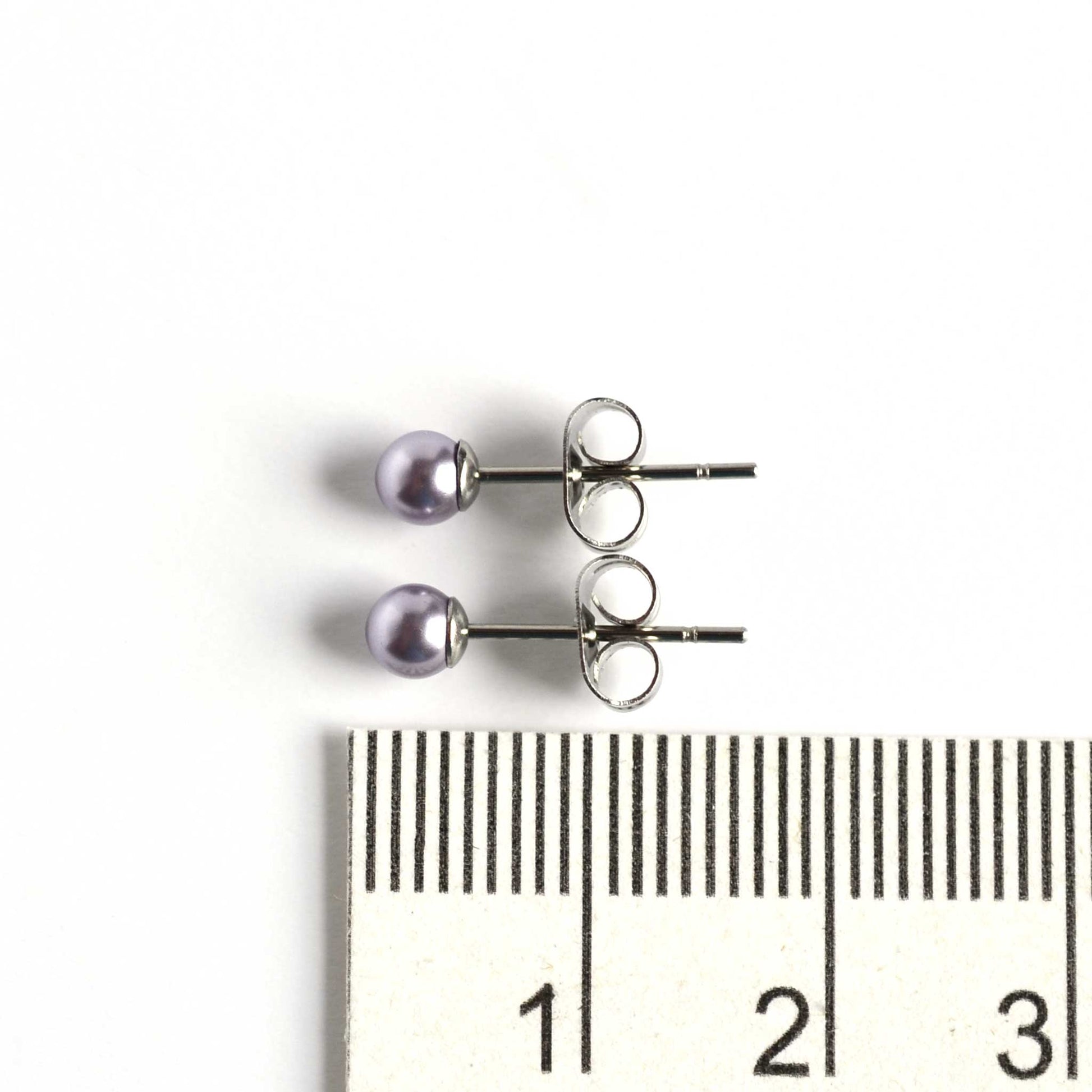 4mm light grey faux pearl stud earrings next to ruler as size guide