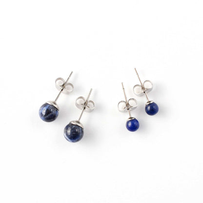 Small and large Sodalite stud earrings laying on white background.