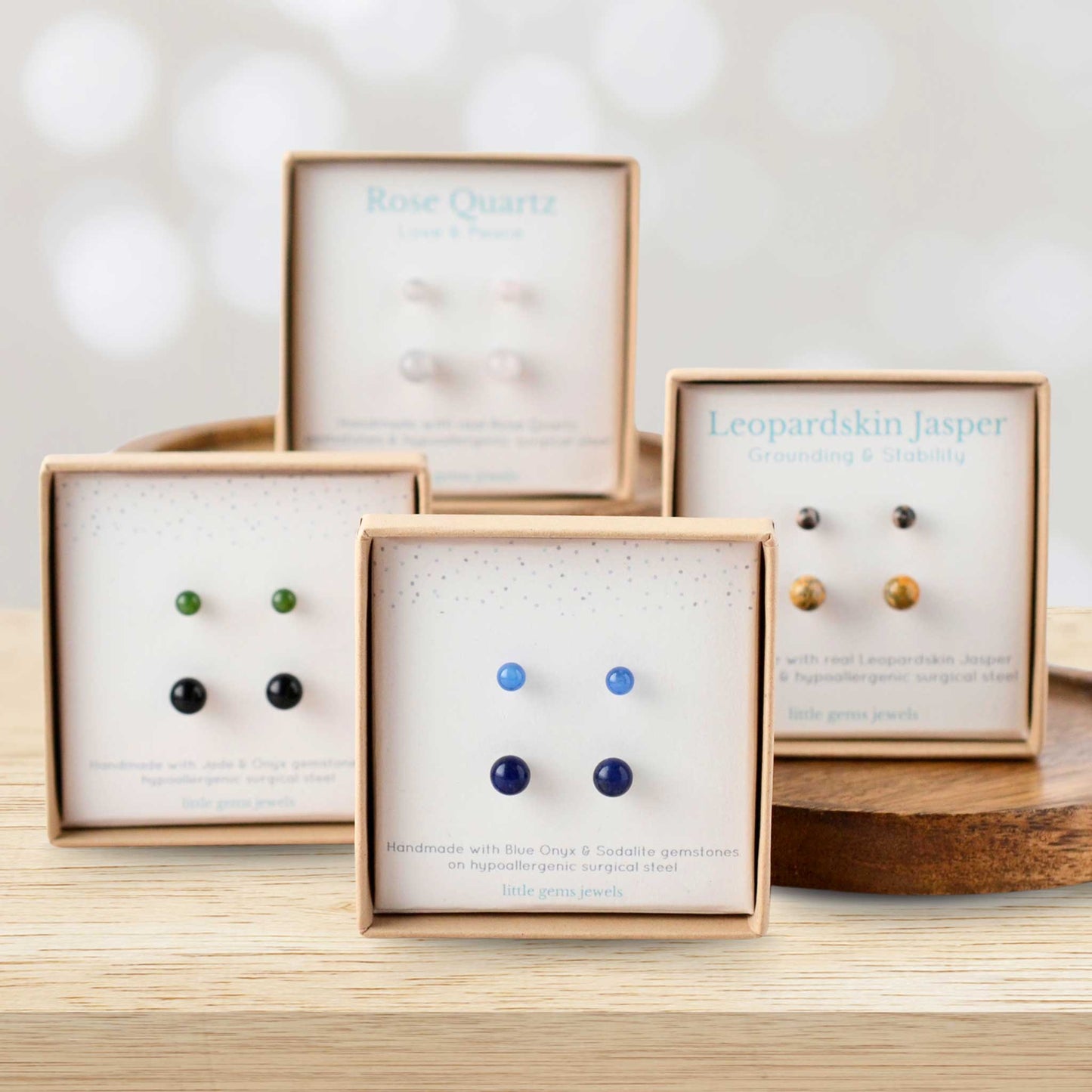 4mm & 6mm gemstone stud earring sets in eco friendly gift boxes displayed on wodden blocks.