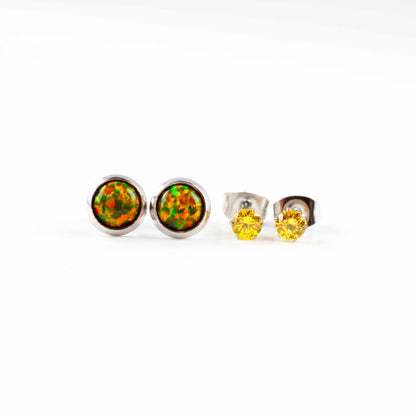 Front view of olive green opal studs and yellow CZ stud earrings on a white background.