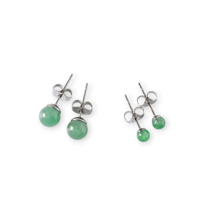 Small and large green gemstone stud earrings on a white background