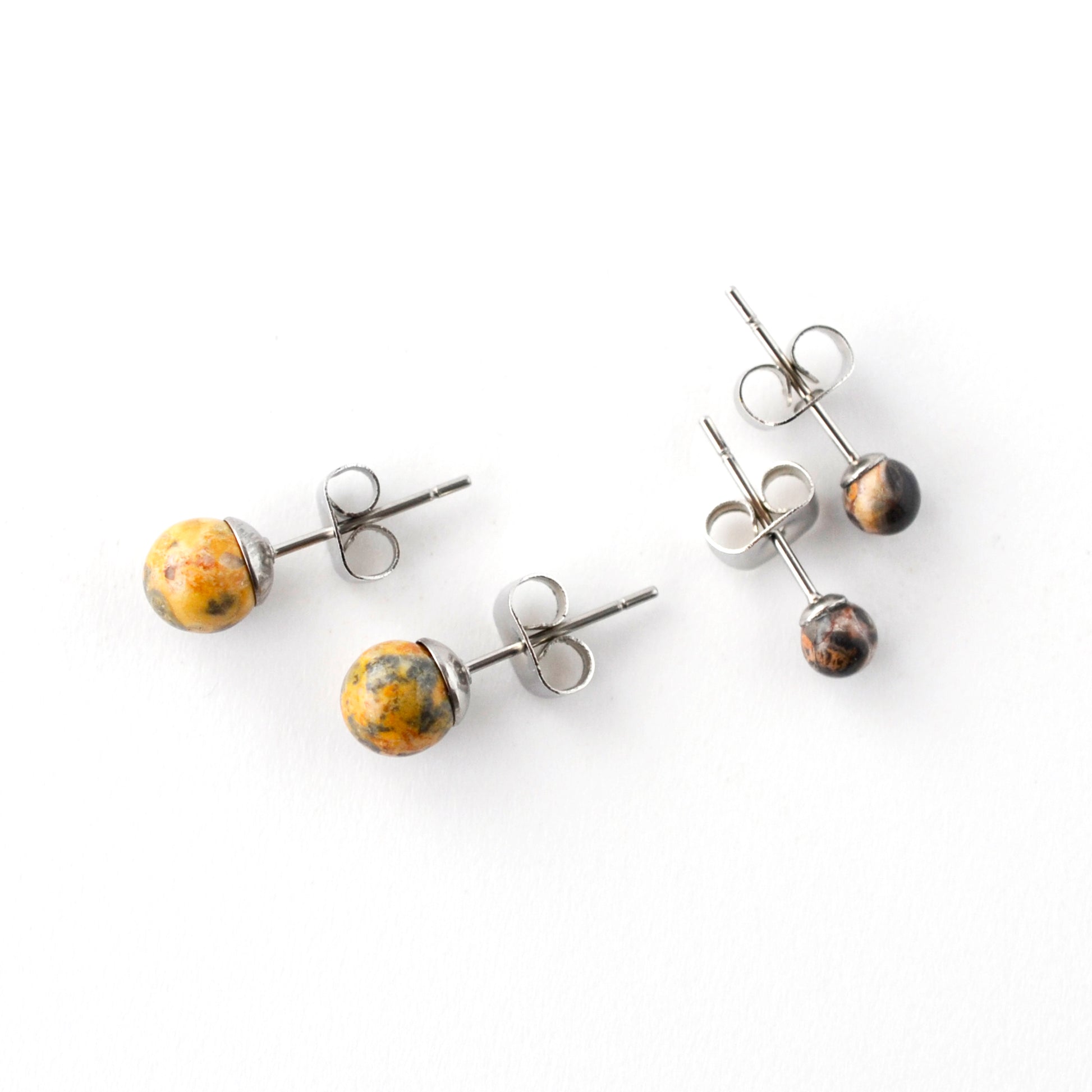 Set of two pairs of Jasper stud earrings on a white background