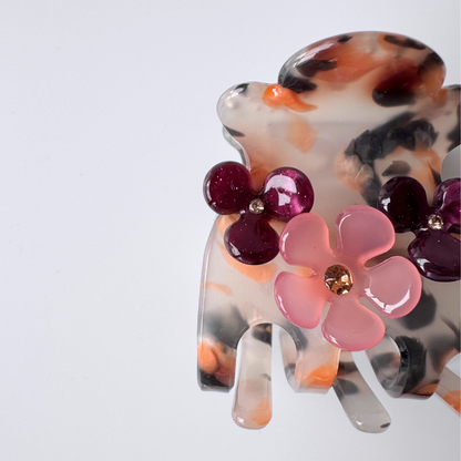 Decorative hair clip with floral design on a white background