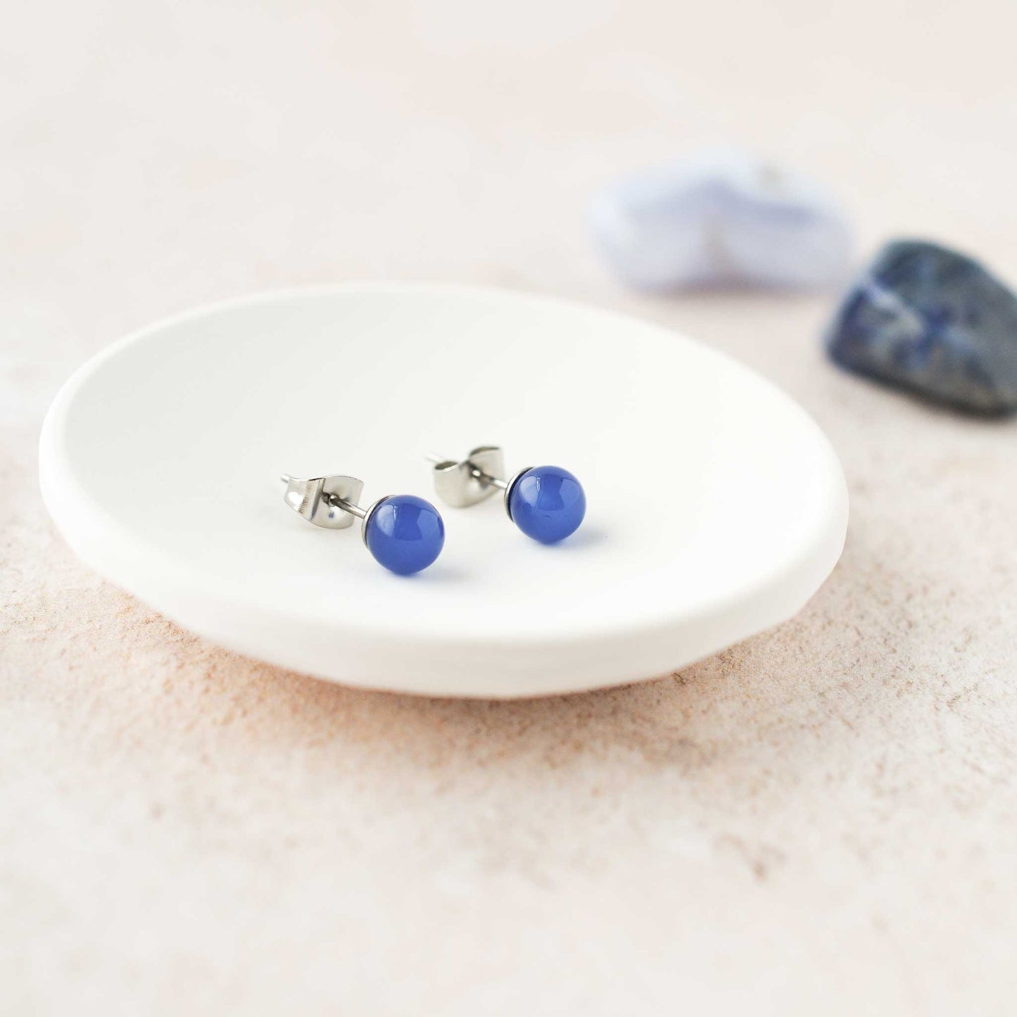 Blue gemstone ball stud earrings in trinket dish