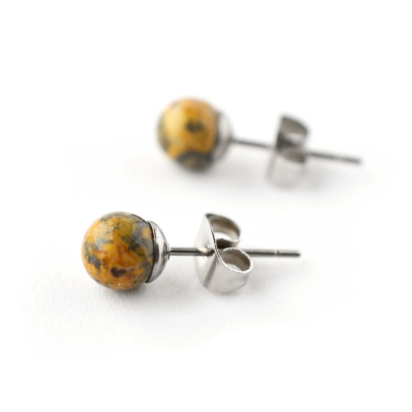 Close up of natural Jasper gemstone ball stud earrings on white background