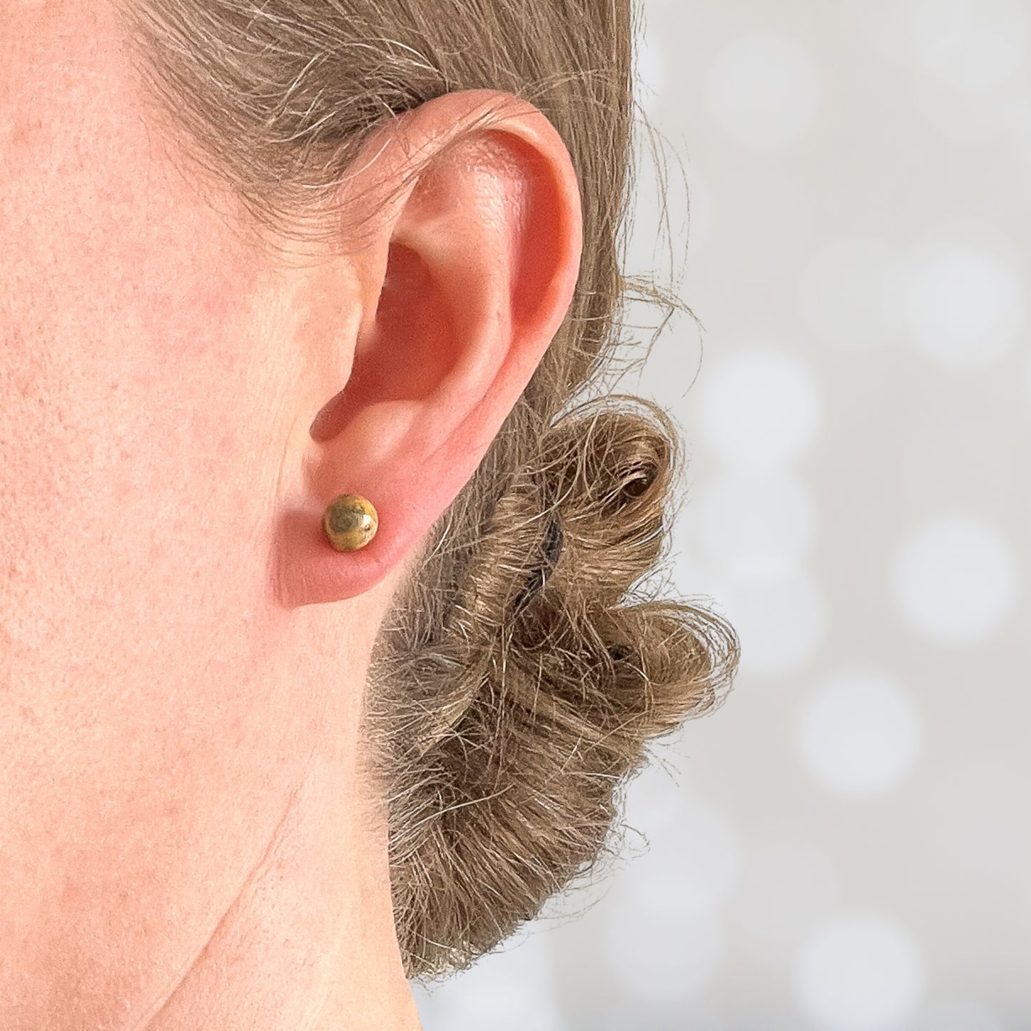 Woman wearing Jasper stud earring in earlobe