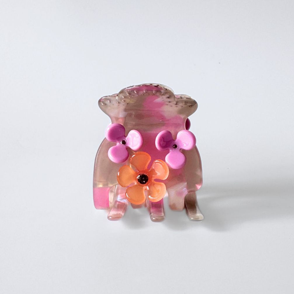 Hair clip with pink and orange floral design on a white background