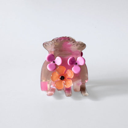 Hair clip with pink and orange floral design on a white background