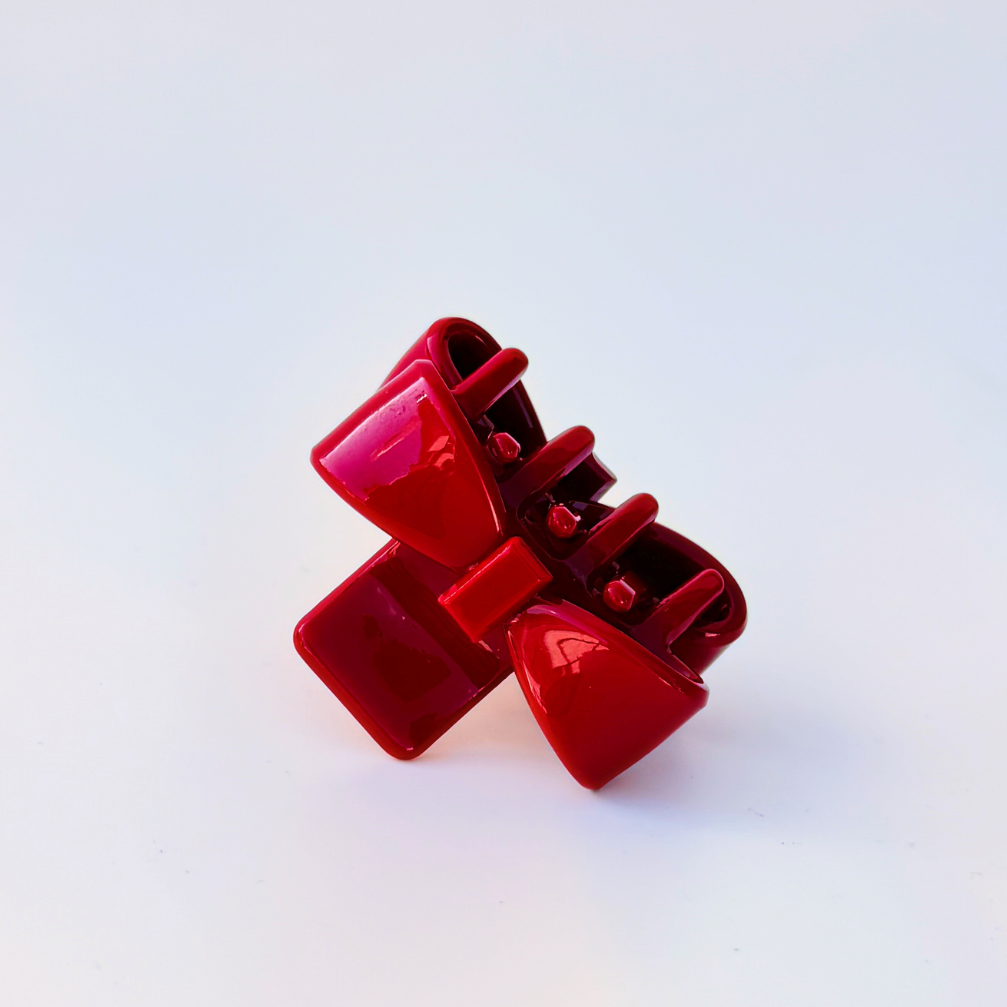 Red hair clip on a light blue background