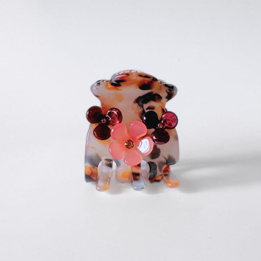 Pink floral hair clip on white background