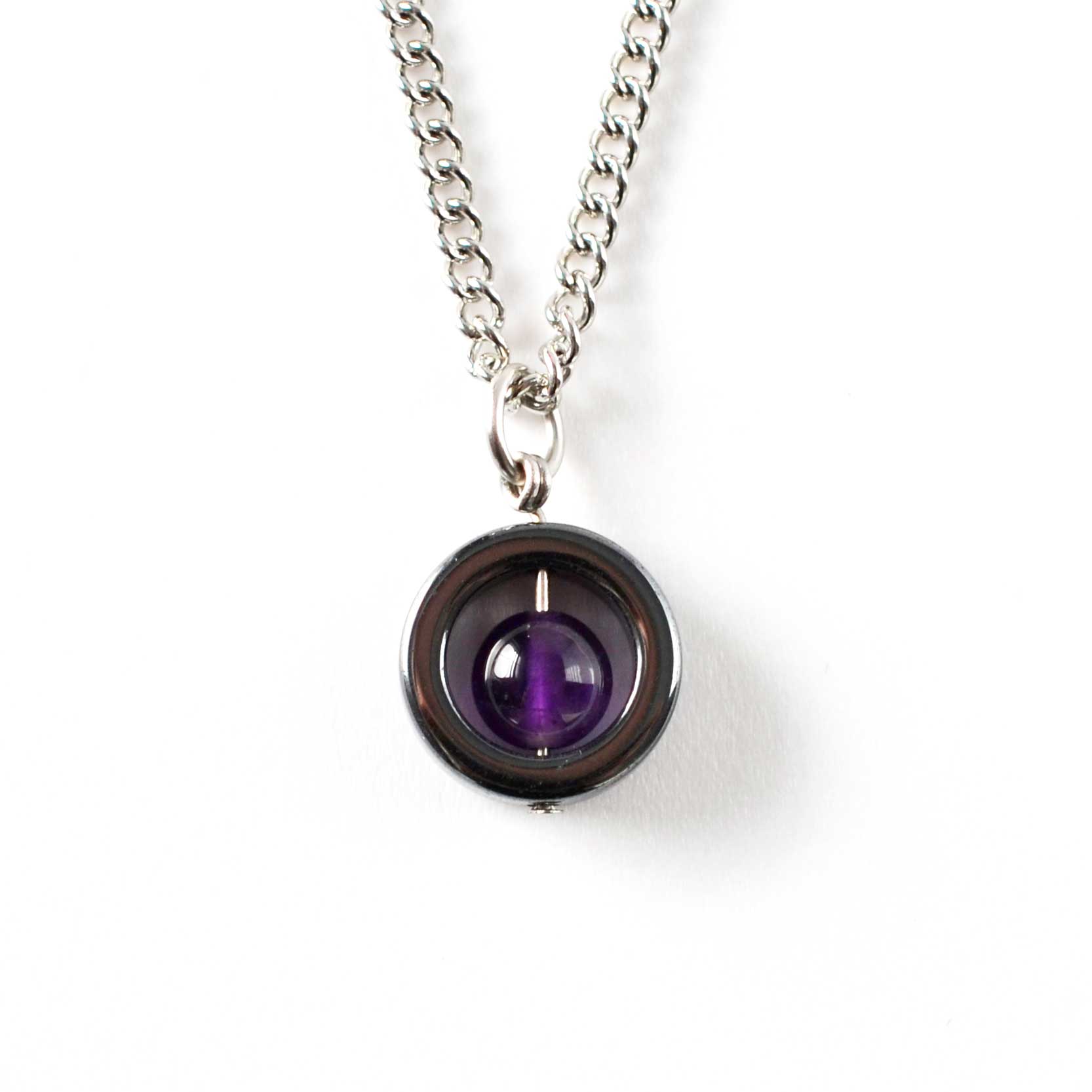 Amethyst & Hematite gemstone spinner necklace on white background.