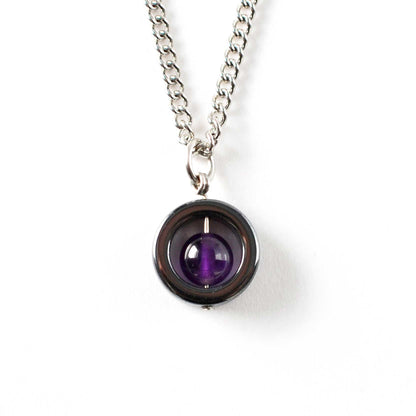Amethyst & Hematite gemstone spinner necklace on white background.