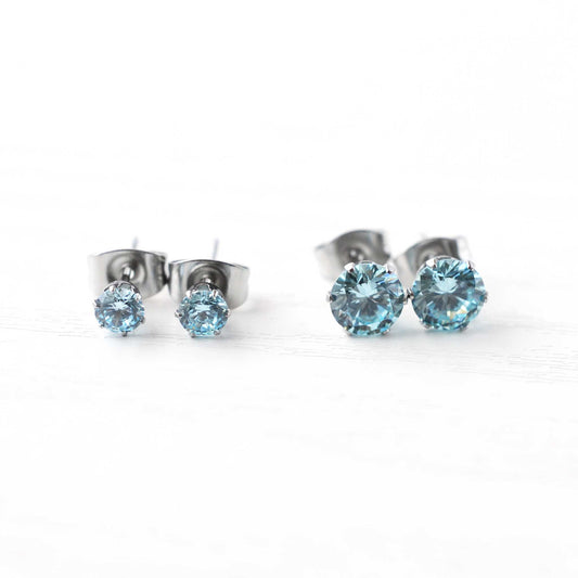4mm & 6mm Aqua Blue CZ Stud Earrings On White Background.