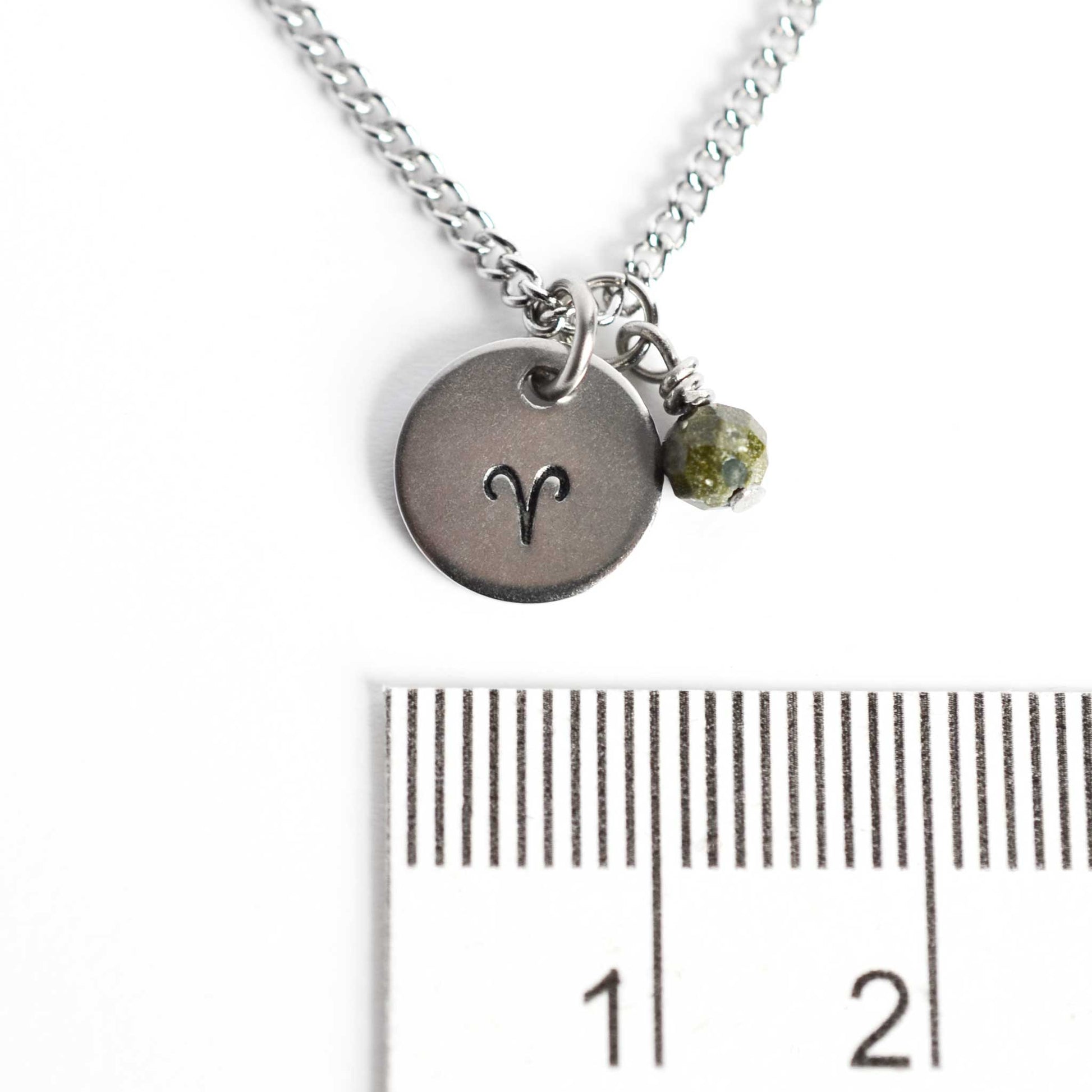 1cm diameter disc pendant with hand stamped Aries zodiac sign and 4mm Bloodstone gemstone charm