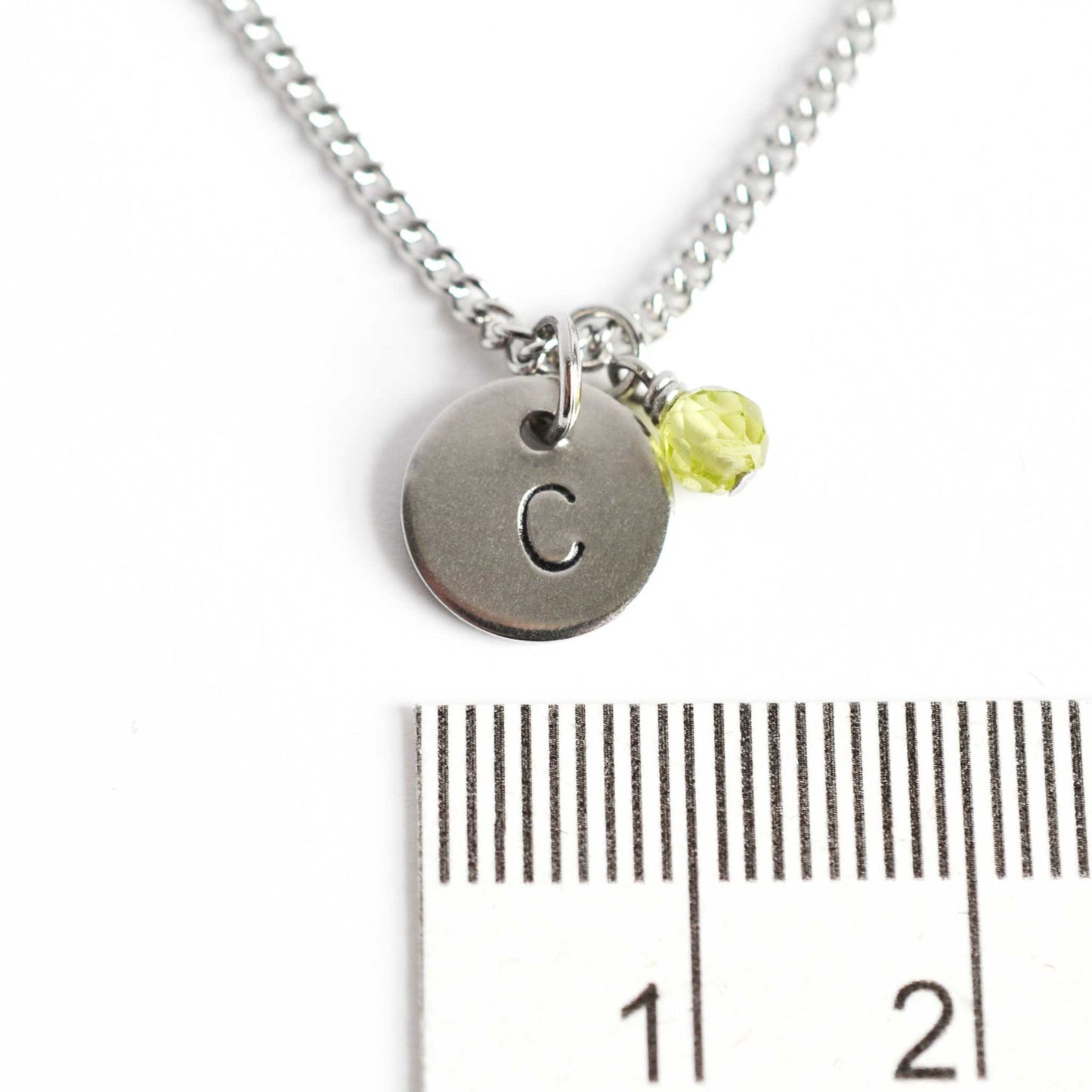 1cm diameter hand stamped initial pendant with 4mm August birthstone charm