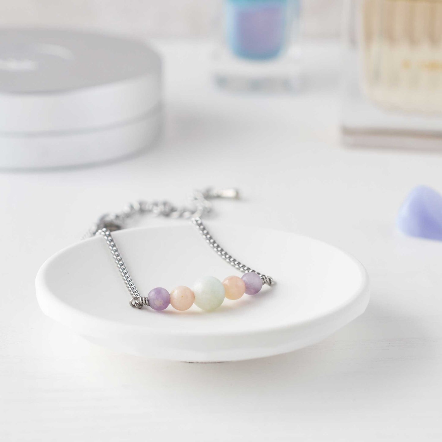 Pastel gemstone bracelet in trinket dish on dressing table
