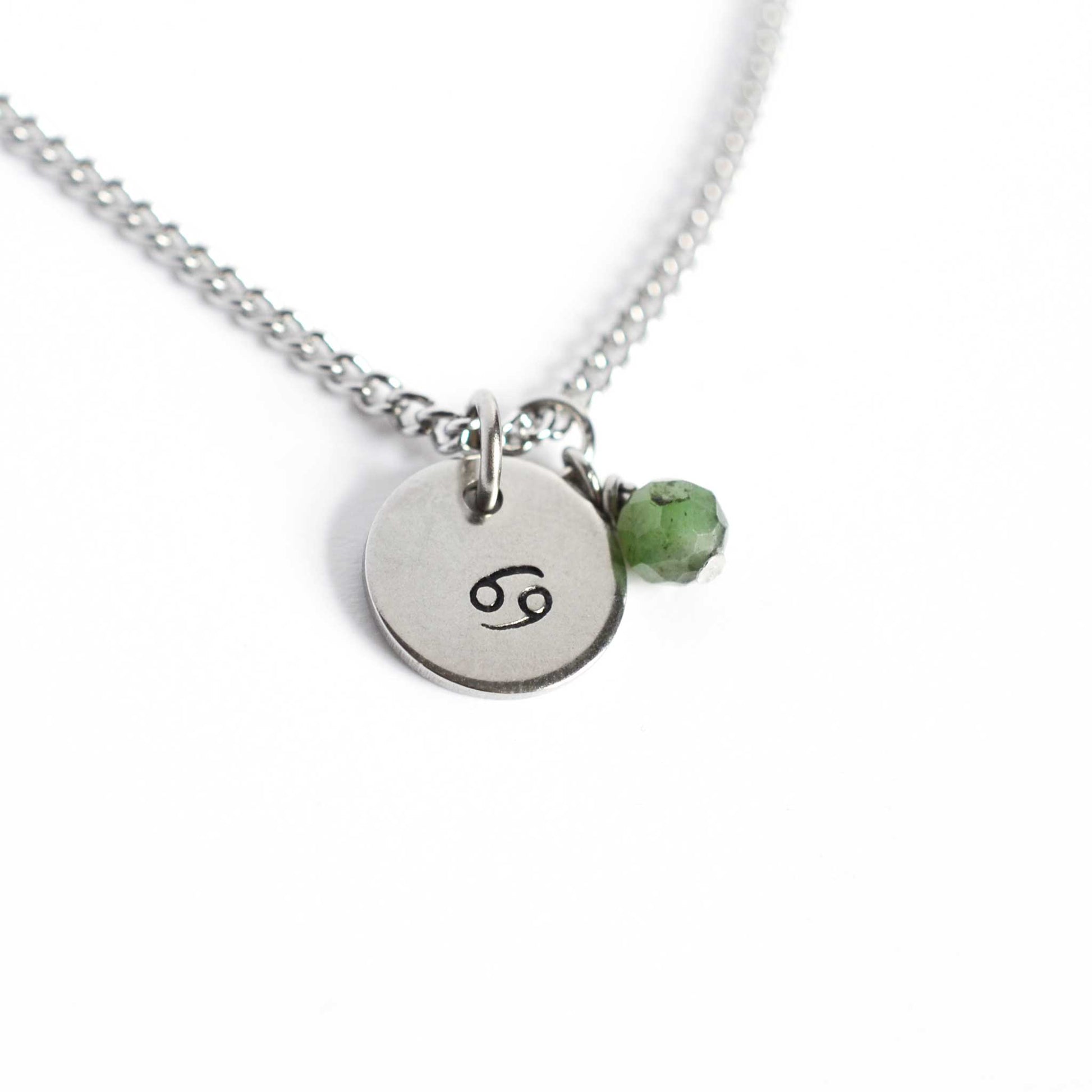 Cancer Zodiac pendant necklace with tiny Emerald gemstone charm on white background