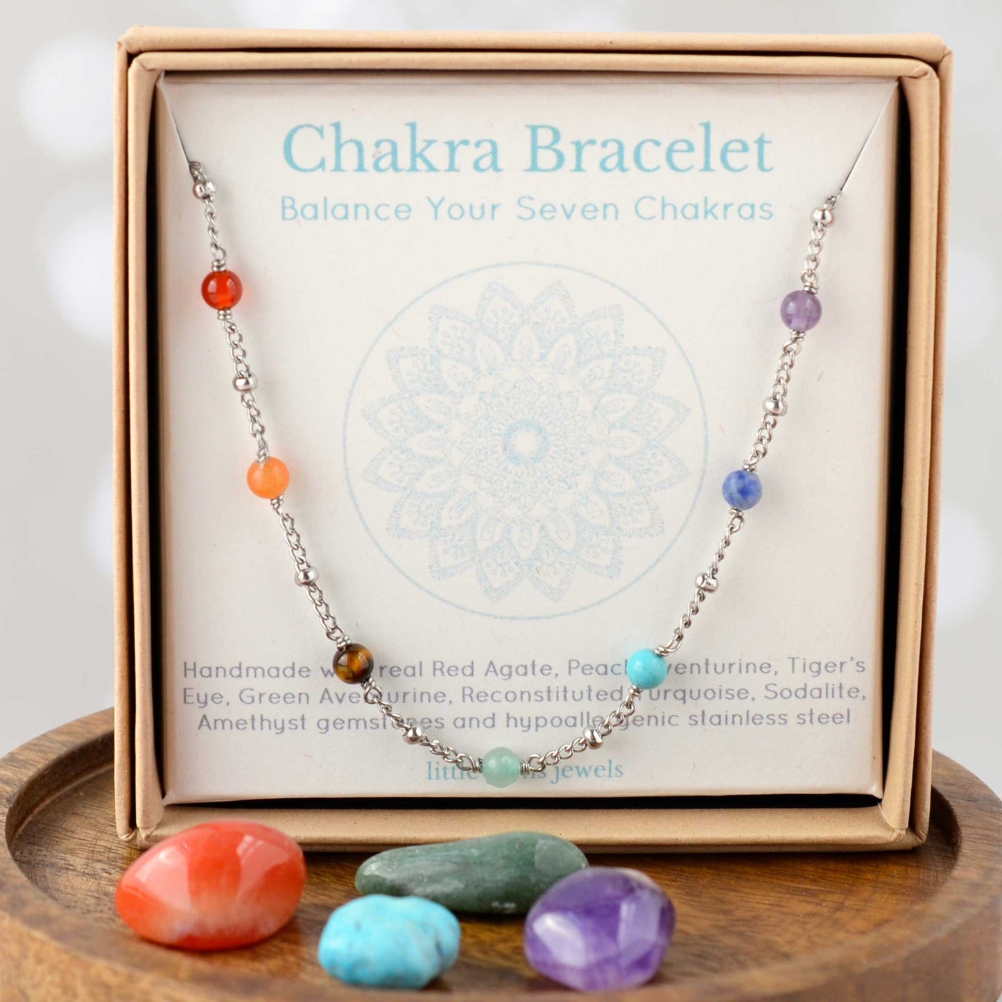 Chakra bracelet in eco-friendly gift box on mandala design gift card.