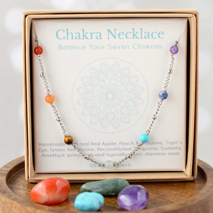 Chakra necklace in eco-friendly gift box on mandala design gift card.
