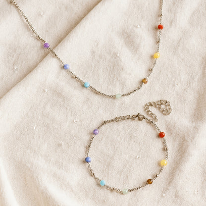 Two beaded necklaces on a beige fabric background