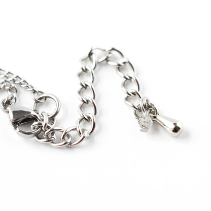 Close up of stainless steel extender chain with Quartz gemstone charm and steel drop