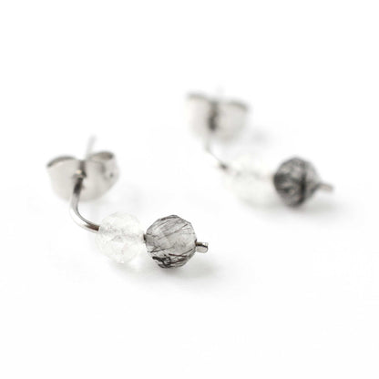 Close up of black Tourmalinated Quartz gemstones on stud earrings