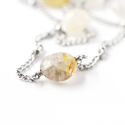 Close up of Rutilated Quartz gemstone nugget bead