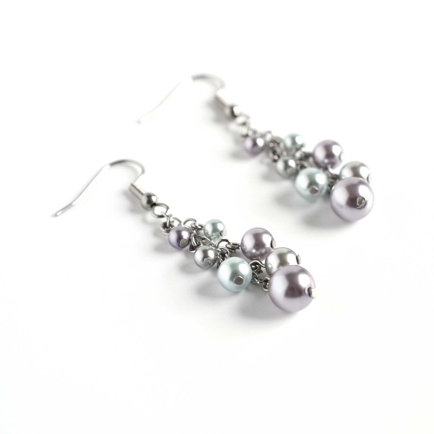 Faux pearl cluster drop earrings on white background