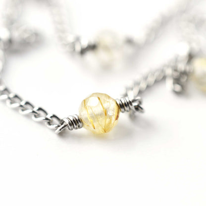 Close up of 4mm Rutilated Quartz beads on stainless steel anklet