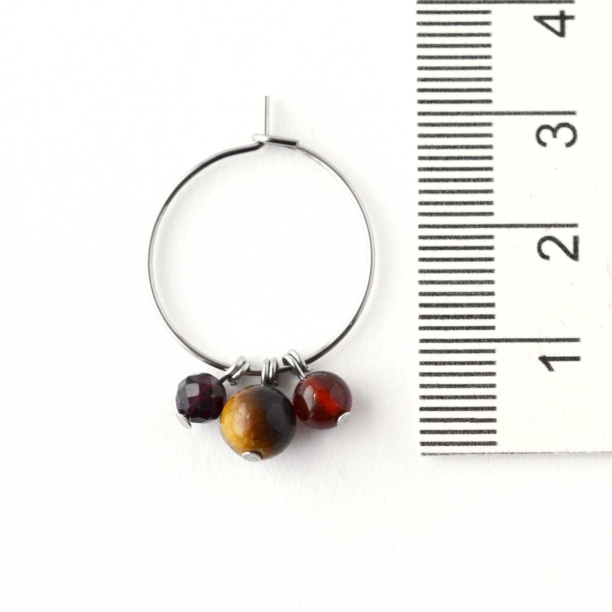 2cm diameter hoop earrings with dark gemstone beads next to ruler