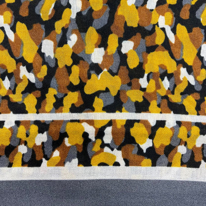 Close-up of a patterned rug with yellow, black, and gray colors.