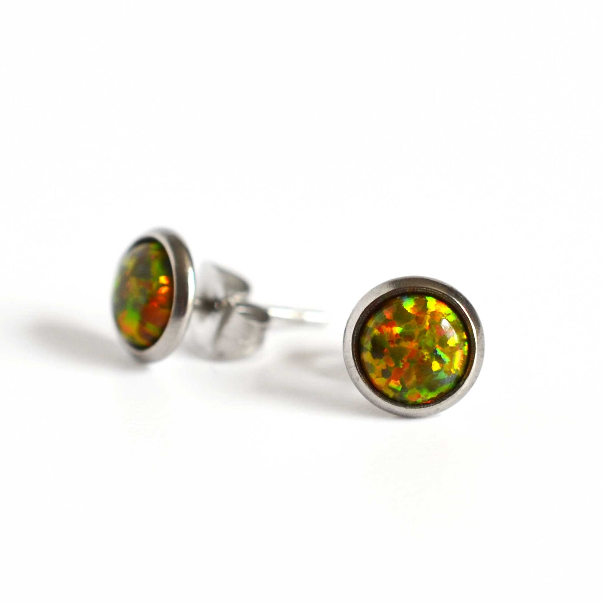 Dark green Opal stud earrings on white background