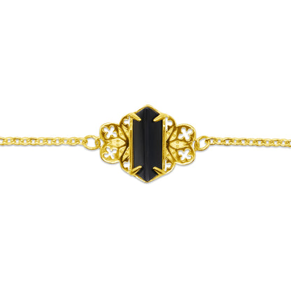 Gold necklace with a black gemstone on a white background
