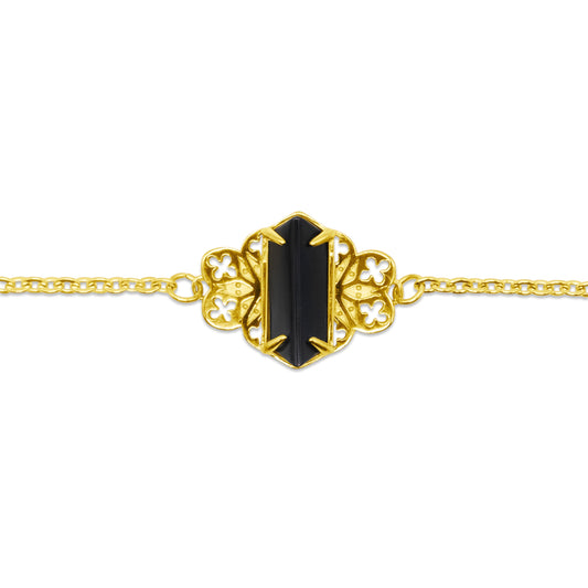 Gold necklace with a black gemstone on a white background