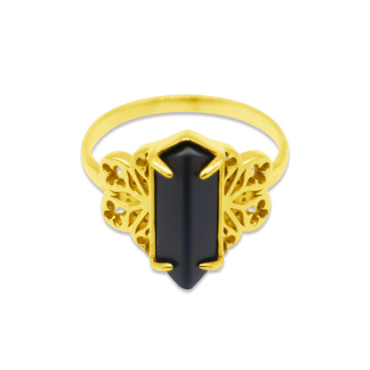 Gold ring with a black gemstone on a white background