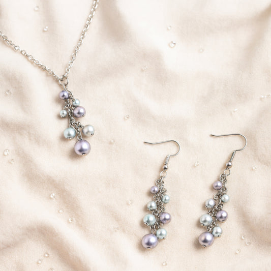 Pearl necklace and earrings on a beige fabric background