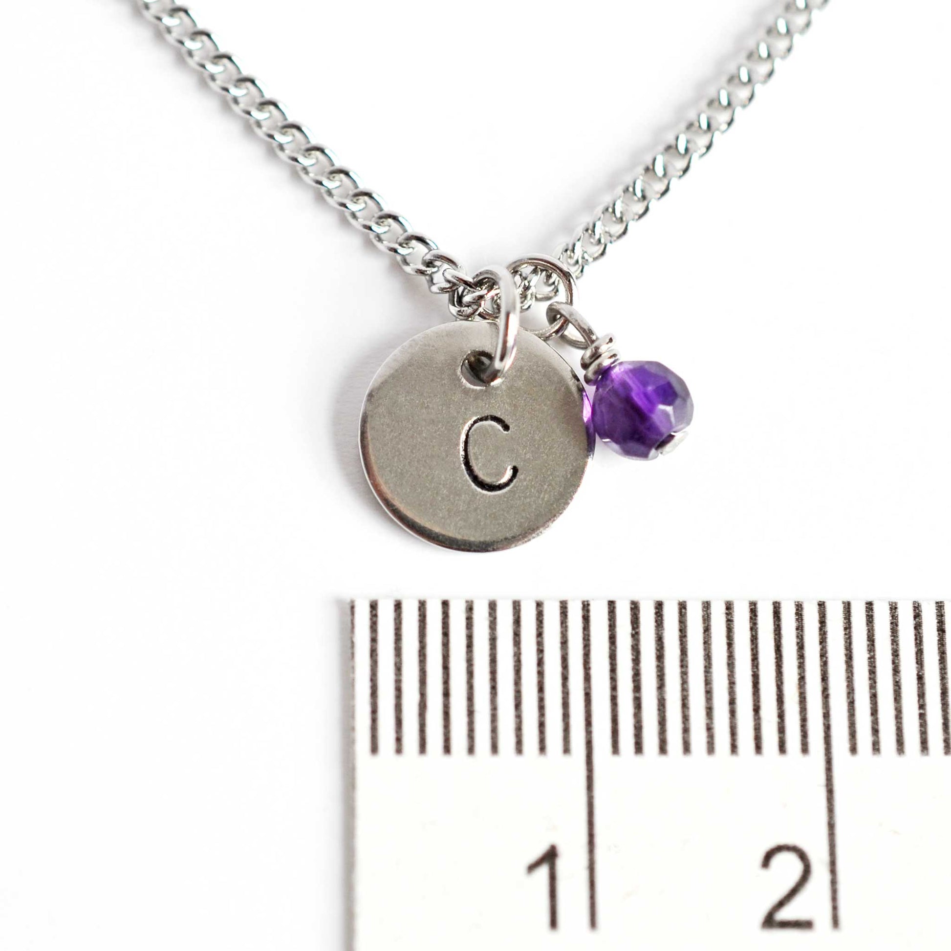 1cm diameter round pendant with hand stamped initial and 4mm birthstone charm