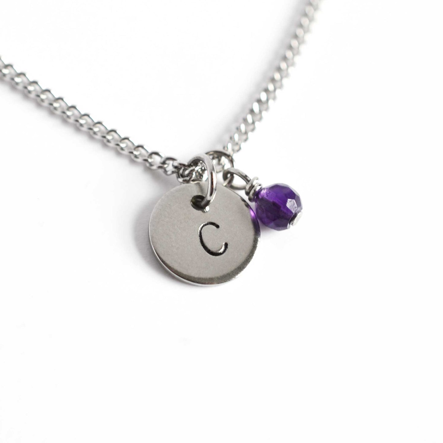 Letter C initial pendant and Amethyst February birthstone necklace on white background