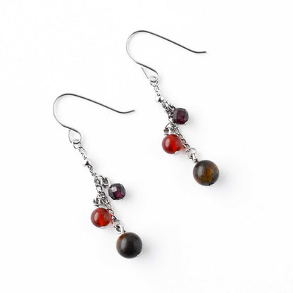Flatlay Tigers Eye, Carnelian & Garnet gemstone drop earrings on white background
