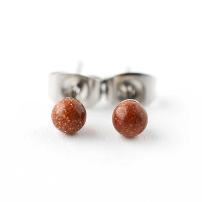 Front view close up of brown Goldstone ball stud earrings