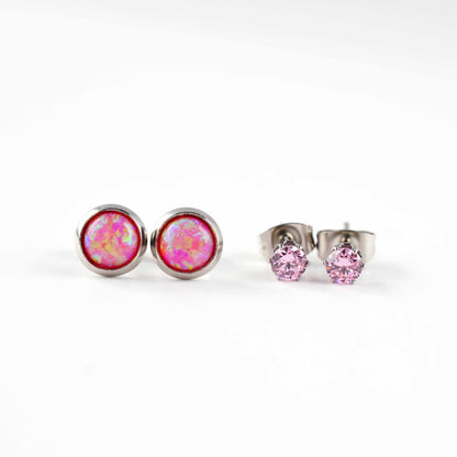 Front view of pink lab opal studs and pink CZ stud earrings on white background.