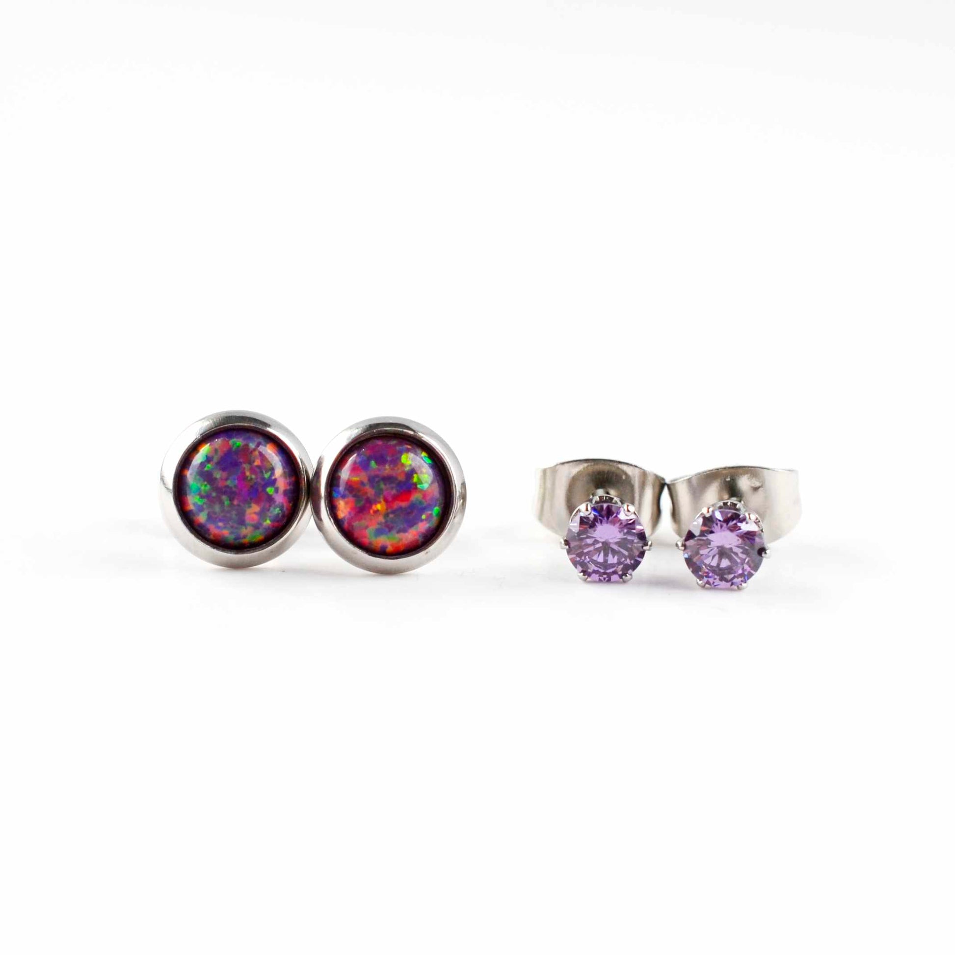 Front view of purple lab opal studs and purple CZ stud earrings on white background.
