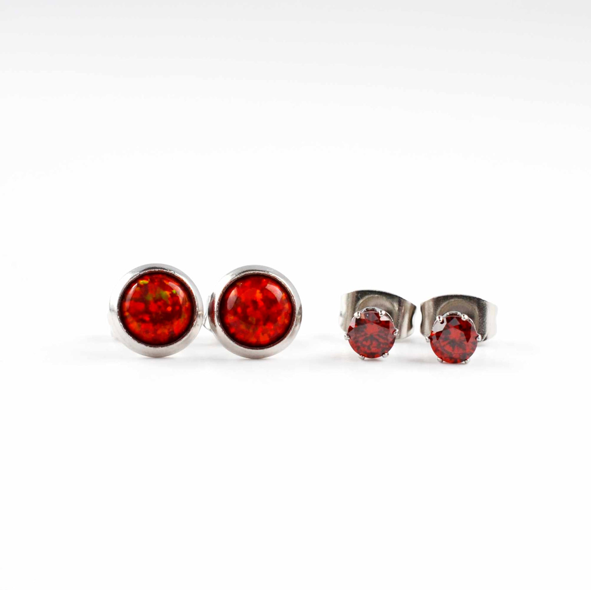 Front view of red lab opal studs and red CZ stud earrings on a white background.