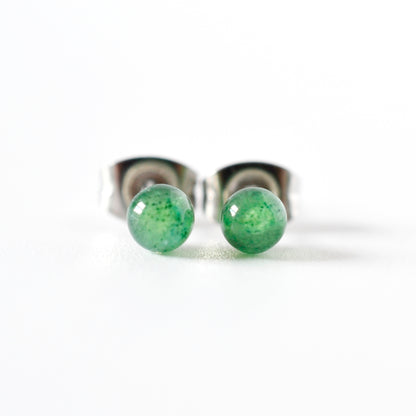 Front view of green gemstone ball stud earrings on a white background