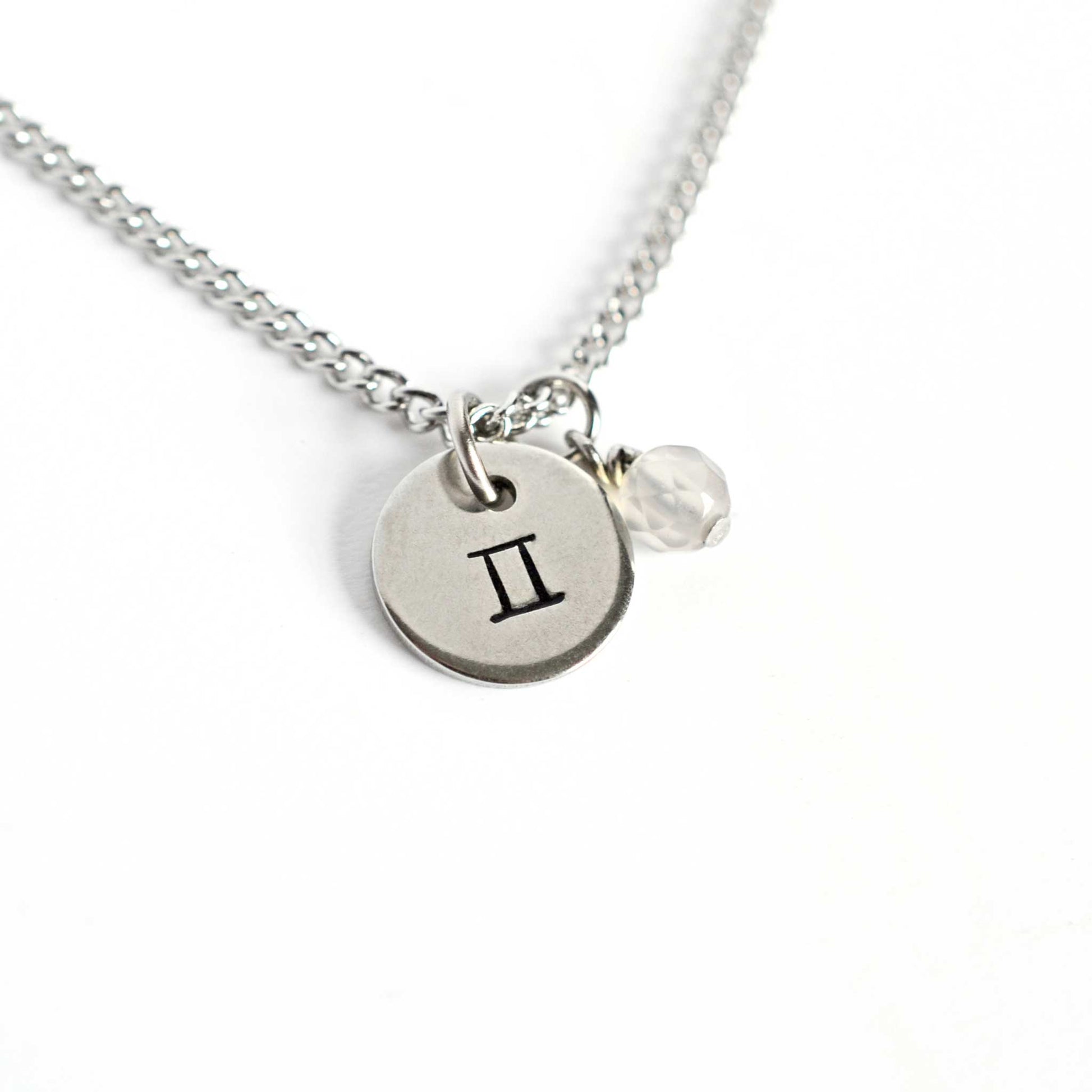 Gemini Zodiac pendant necklace with tiny Agate gemstone charm on white background