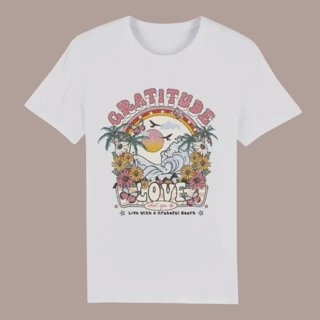 White t-shirt with a colorful graphic design on a beige background