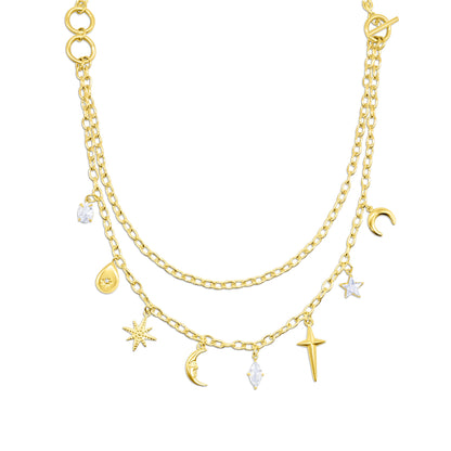 Gold layered necklace with various charms on a white background