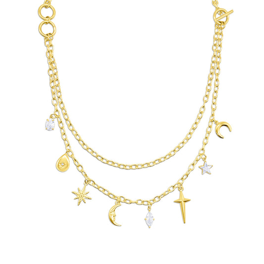 Gold layered necklace with various charms on a white background