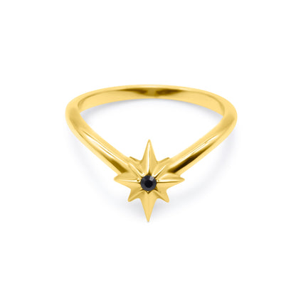 Gold ring with star-shaped design and black gemstone on a white background