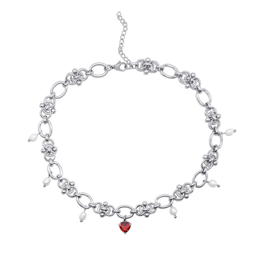 Stainless steel necklace with a red heart charm on a white background